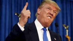 Republican presidential candidate Trump gestures and declares "You're fired!" at a rally in Manchester