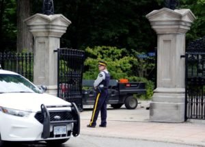 FILE PHOTO: A police officer stands near a damaged gate at Rideau Hall in Ottawa