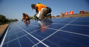 Vivint Solar technicians install solar panels on the roof of a house in Mission Viejo