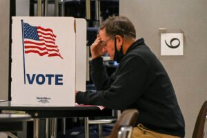 A voter casts their ballot at a polling station at Virginia Run Elementary School in Centreville, Va., on Election Day, Nov. 2, 2021. (Kenny Holston/The New York Times)