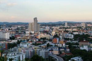 Thailand pattaya city view from hill. Cityscape under bluy cloudy sky.